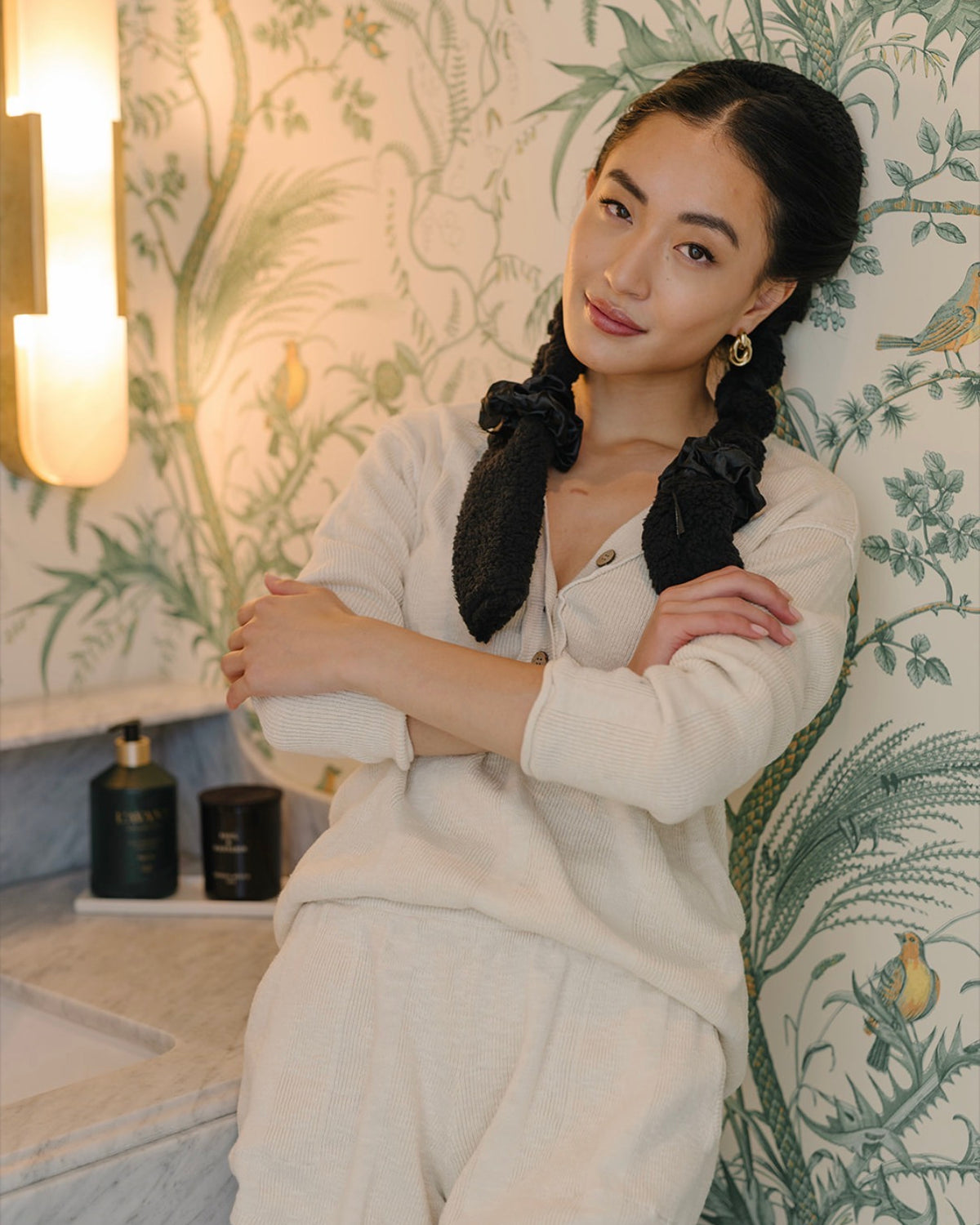 Woman in cream loungewear with hair wrapped in a black Classic CurlBand