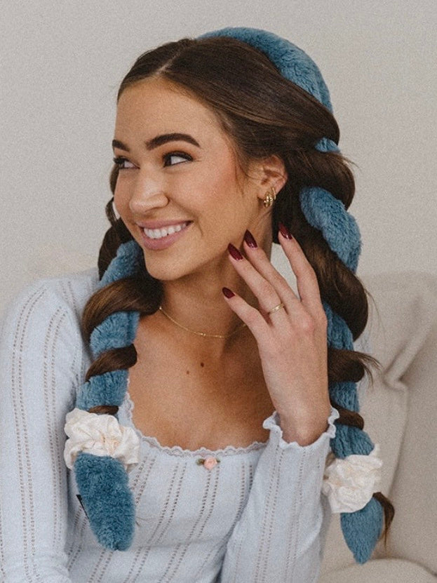 Smiling brunette with two braids wrapped in blue Blowout CurlBands and cream scrunchies