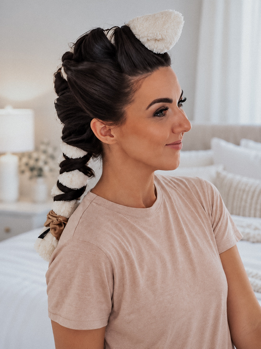 Woman with dark hair wrapped in a cream CurlBand™ using the unicorn method for heatless curls