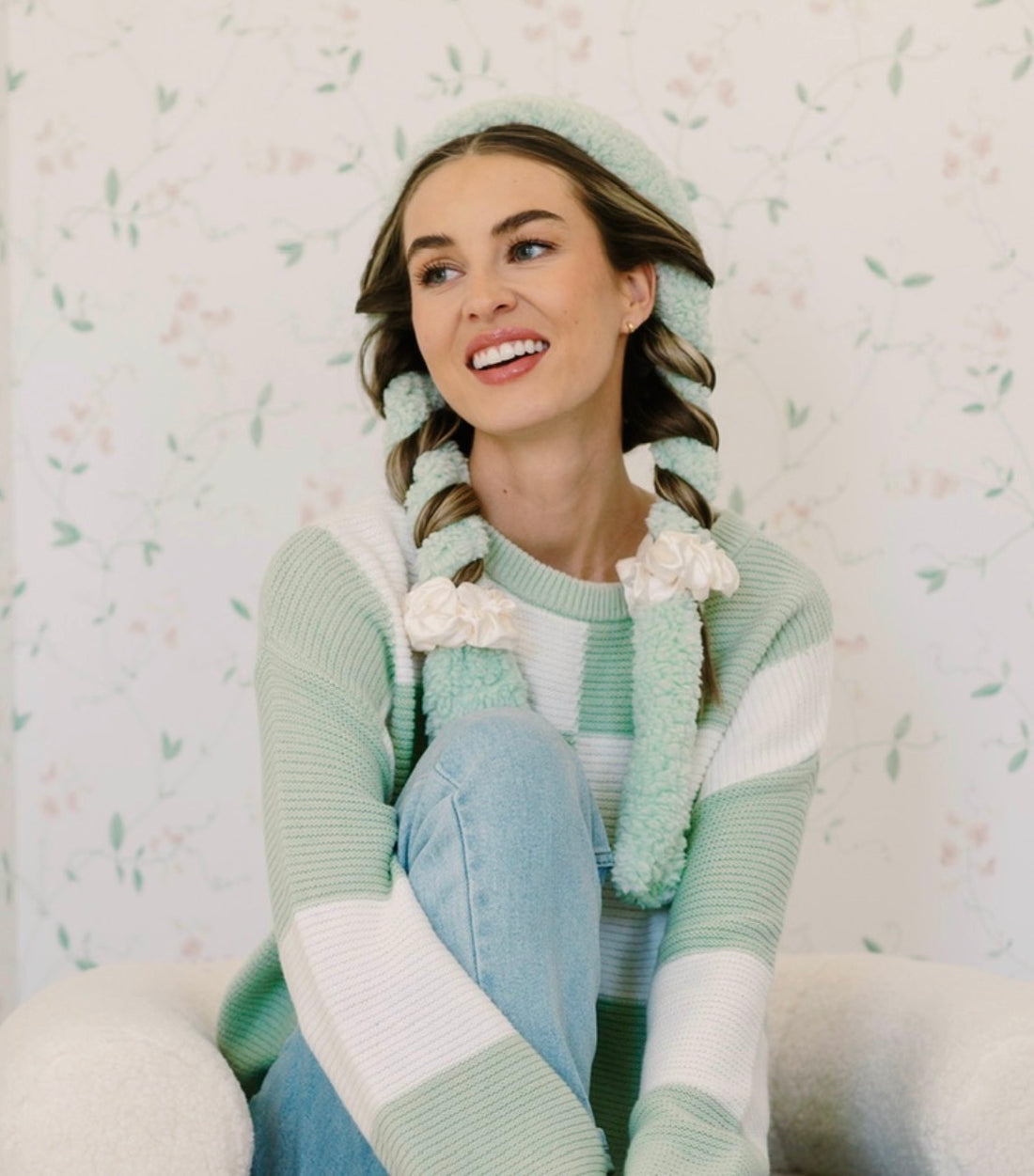Smiling woman with her hair wrapped in a sage CurlBand with cream scrunchies