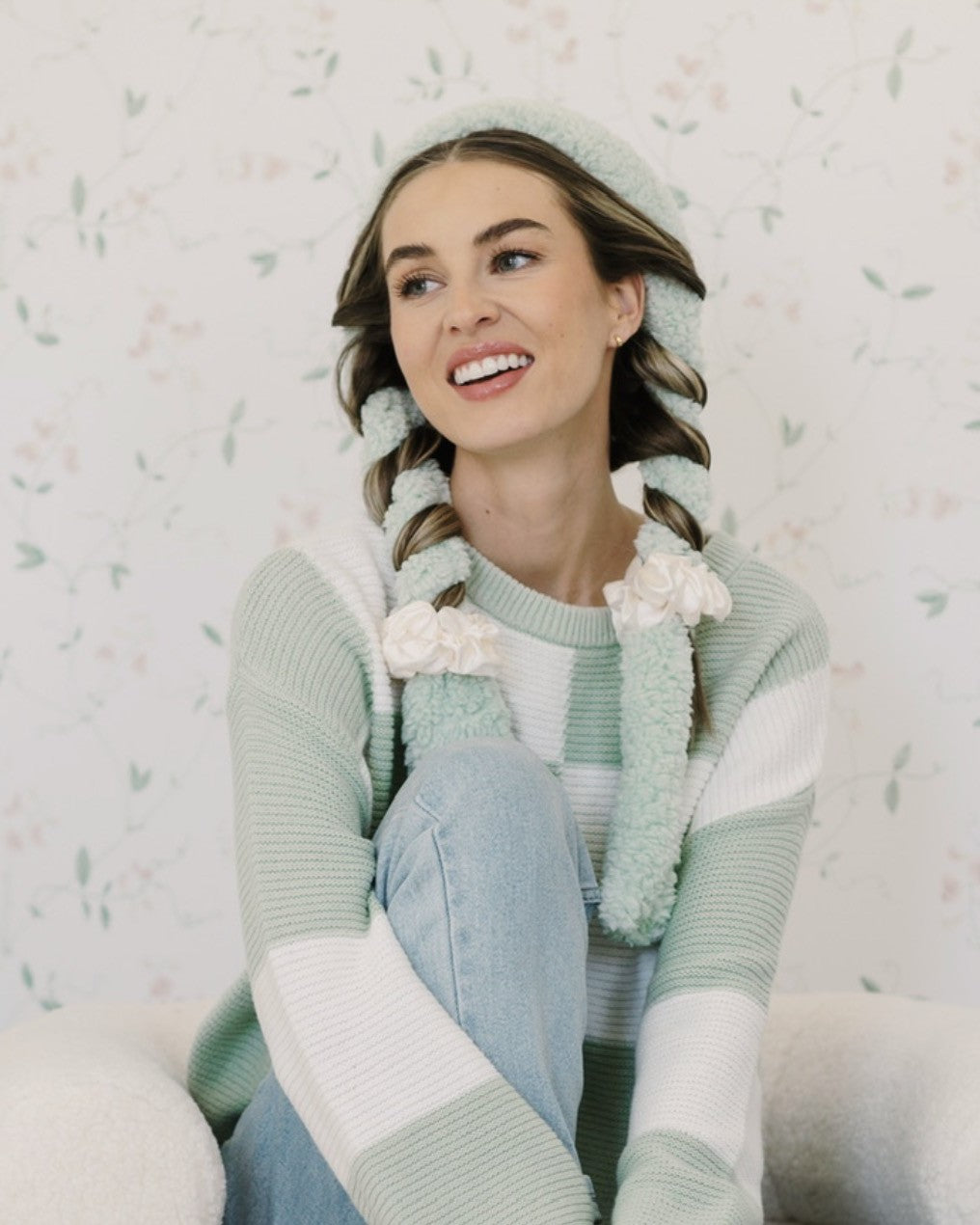 Smiling woman with her hair wrapped in a sage CurlBand with cream scrunchies