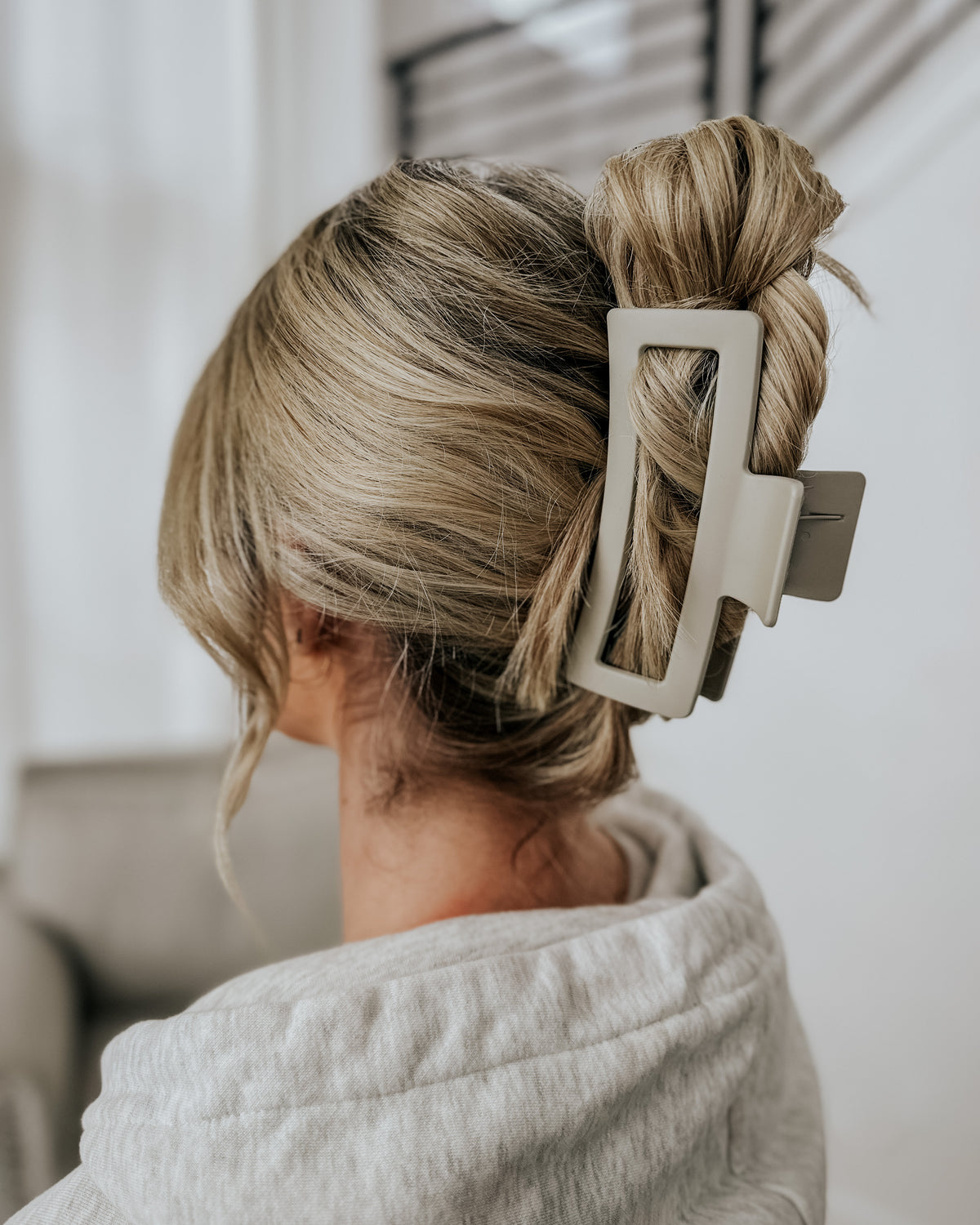Ivory XL Cozy claw clip holding a blonde updo