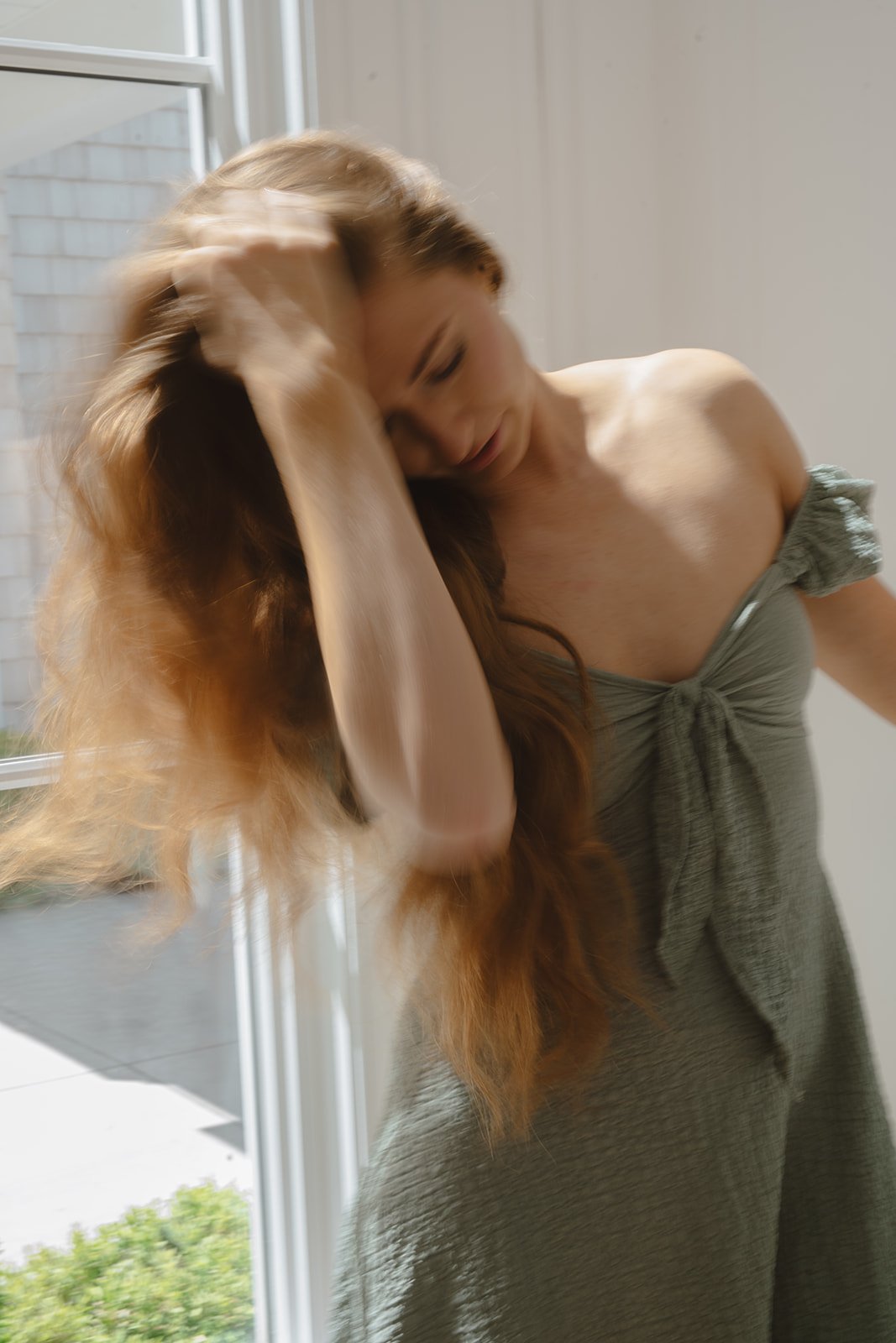 Elisabeth running her hand through thick, wavy red heatless curls