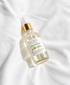 A clear glass bottle of non-toxic safe fragrance for hair, body and home.  Rich golden citrus scent.