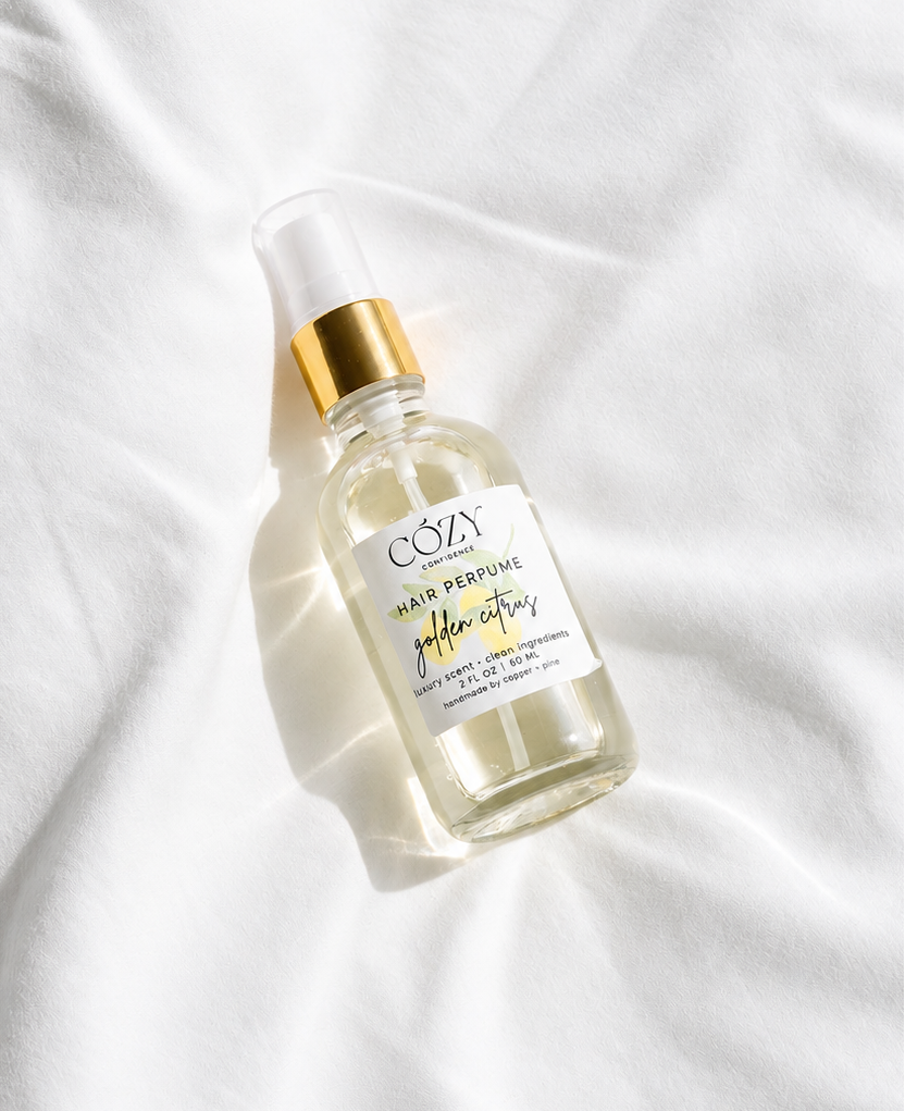 A clear glass bottle of non-toxic safe fragrance for hair, body and home.  Rich golden citrus scent.