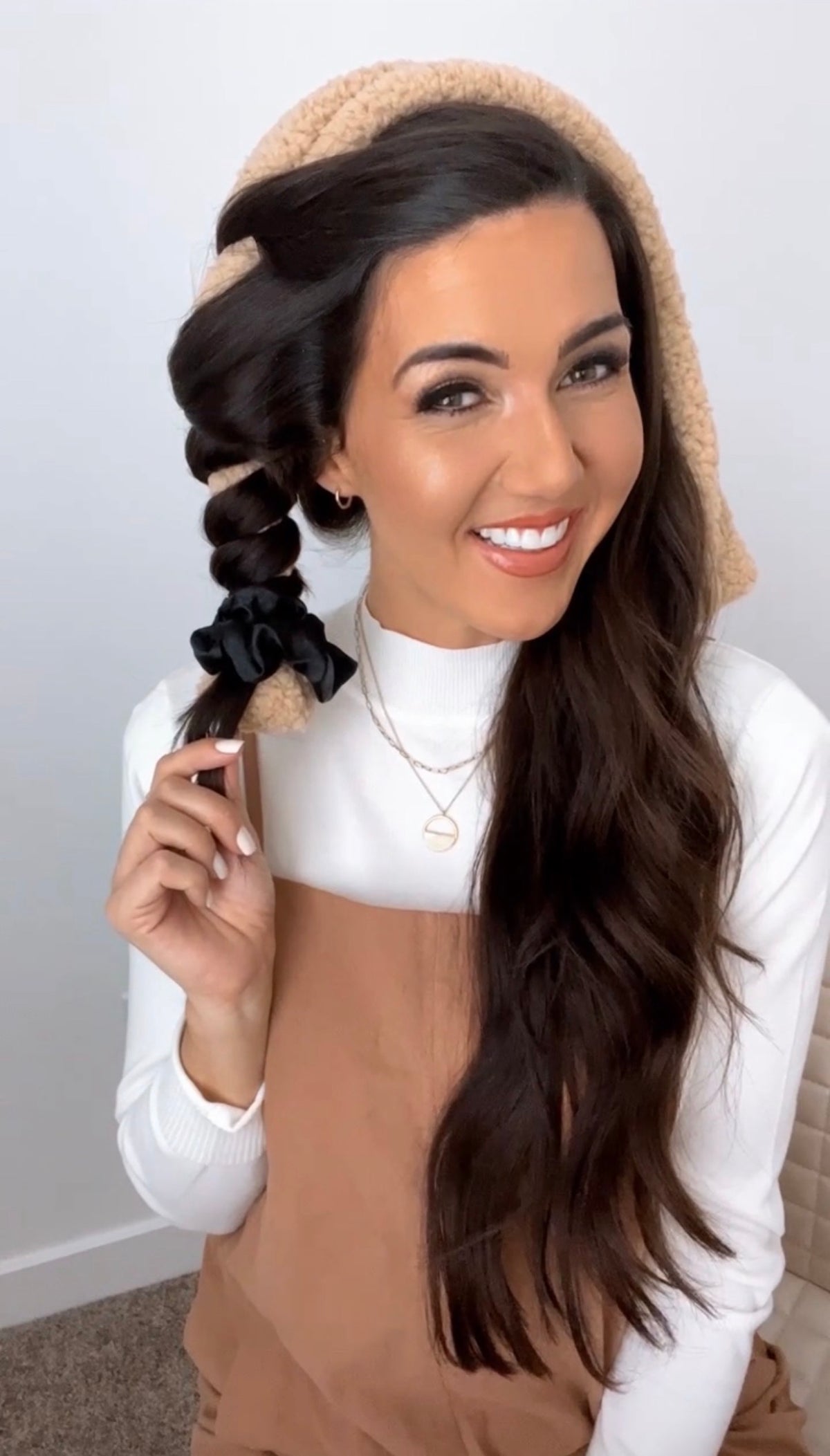 Woman with dark hair wrapped in a tan CurlBand&trade; using the doubled up method for heatless curls