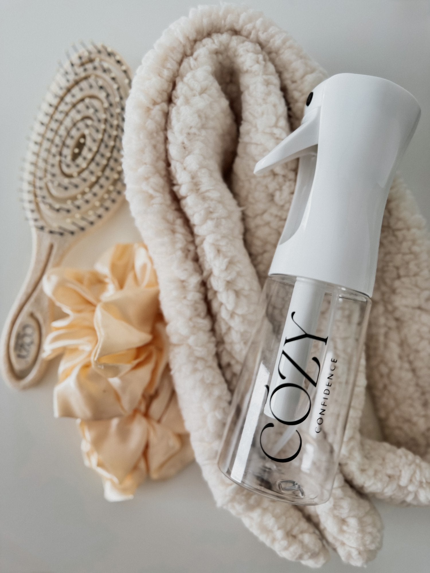 Vanilla Curl Kit for heatless curls with a cream textured CurlBand, buttercream silk scrunchies, beige Volume Brush and white Cozy Confidence spray bottle